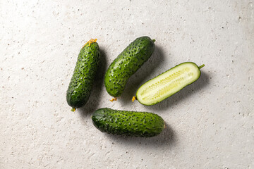 Farmer cucumbers top view on light concrete background
