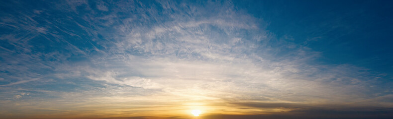 Fototapeta premium Dramatic sky with beautiful clouds at sunset in the evening. Beautiful cloudscape.