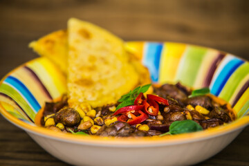Chicken hearts in the Mexican way with a pancake. The food in the restaurant. Food styling and restaurant meal serving.