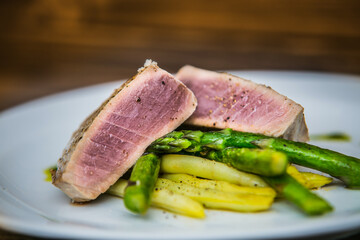 Tuna steak with asparagus and bean pods. The food in the restaurant. Food styling and restaurant meal serving.