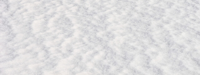 White snow surface background - top view of fresh snow texture on the ground, closeup, panorama, banner