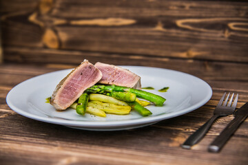 Tuna steak with asparagus and bean pods. The food in the restaurant. Food styling and restaurant meal serving.