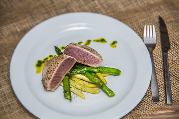 Tuna steak with asparagus and bean pods. The food in the restaurant. Food styling and restaurant meal serving.