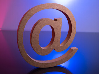 Tagging Email Symbol made with Wooden letter on color light backgronud.