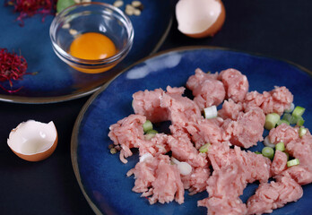 Minced turkey meat on dark background, food photography, cooking concept