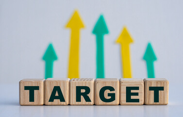 TARGET - word on wooden cubes on a light background with arrows up