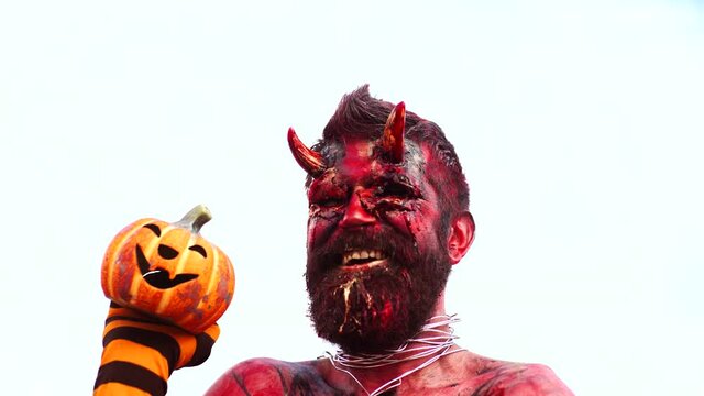 Halloween in blood. Devil head bloody face. Scary horrorwith spooky monster. Evil portrait with horns. Demon or satan. Fantasy art project for holiday. Realistic gothic monster zombie.