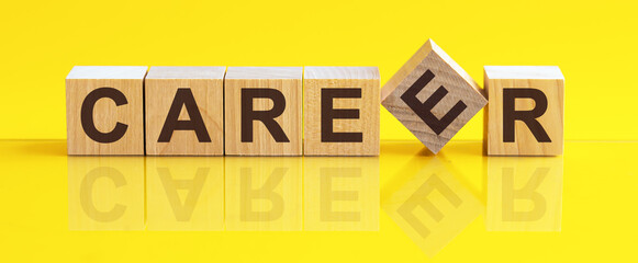 Word Career is made of wooden building blocks lying on the table and on a light yellow background.