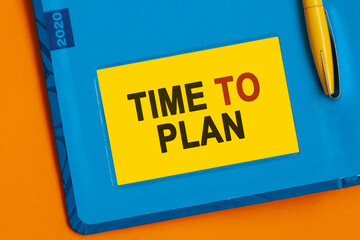 The words TIME TO PLAN is written in black letters on the yellow paper for notes.