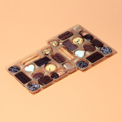 Assorted Box Chocolates and Cookies. Minimal still life fashion food concept