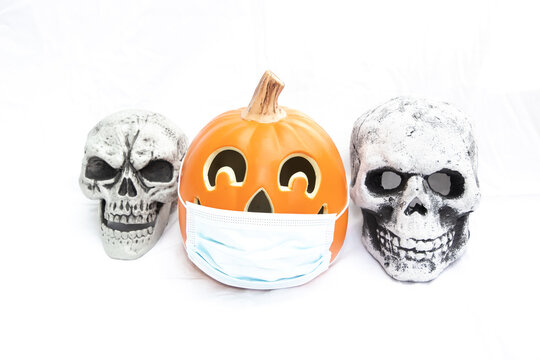 Corona Halloween  pumpkin in a mask with skulls