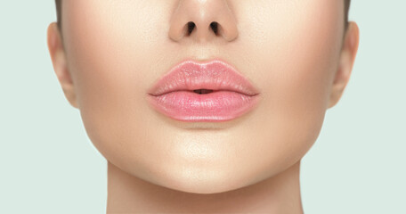 Beautiful young woman's lips closeup. Plastic surgery, fillers, injection. Part of the model girl...