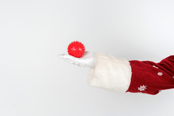 Santa Claus is holding a virus in his hands. Isolated on white