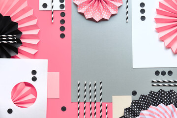 Abstract background on layered paper. Folded paper fans and confetti in black, pink and white.