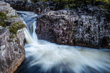 long exposure shot of the waterfalls in glen etive near loch etive and the entrance to glencoe and rannoch moor in the argyll region of the highlands of scotland during summer