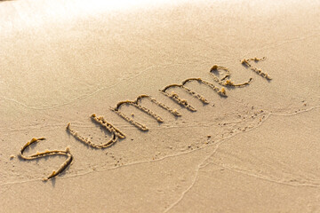 Summer written on the sandy shore. Summer ended and was washed away by a wave. Summer background. - 384883687
