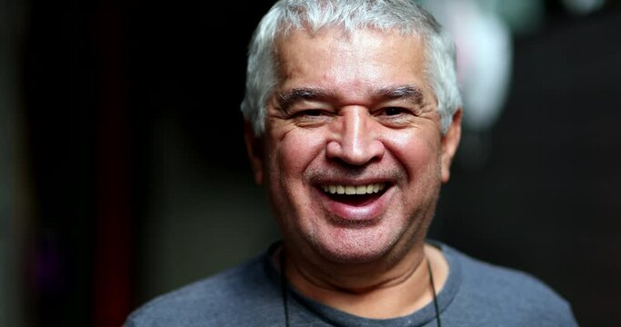 Older senior man smiling and laughing at camera, real life casual person