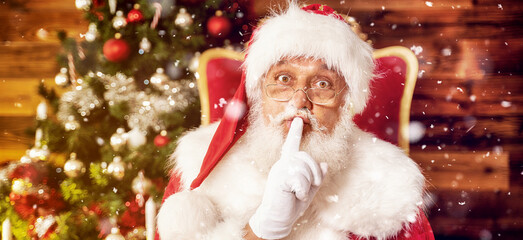 Real Santa Claus showing silence sign.