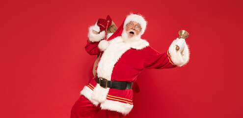 Funny Santa Claus holding sack bag with Merry Christmas presents.