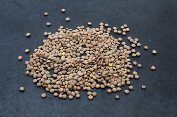 Flat lay of a pile of lentils scattered on black
