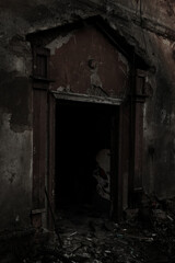 Fototapeta na wymiar Door to an abandoned building that looks like a house of horrors