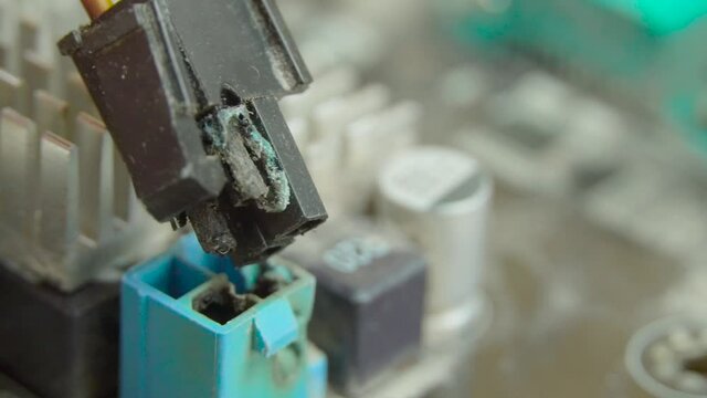 The colored connectors in the computer are charred and burned after over-voltage. The wizard shows the processor power to the camera. Failure of the motherboard and power supply.