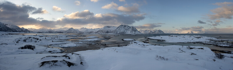Travel in wild Norway. Wild range of mountains in the Lofoten. Wintertime in Scandinavia. Snow blanket mountains.