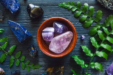 Bowl of Amethyst with Zodiac Stones of Sagittarius on Blue Background