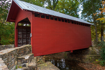 wooden covered bridge in the forest