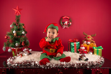 Obraz na płótnie Canvas Adorable child, in Christmas decoration and elf dress