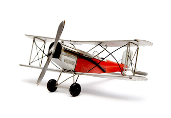 Metal toy, a colorful old biplane on white background