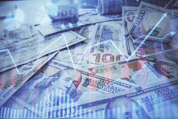 Multi exposure of forex chart drawing over us dollars bill background. Concept of financial success markets.