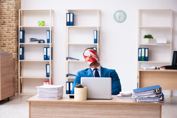 Mouth and eyes closed male employee working in the office