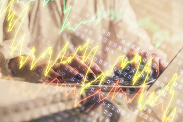 Double exposure of woman hands typing on computer and forex chart hologram drawing. Stock market invest concept.