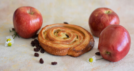 Freshly baked red apple and raisin roll for Sunday breakfast.