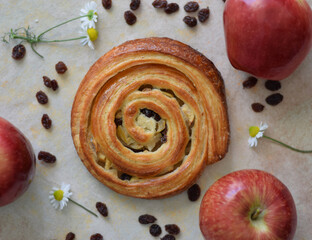 Freshly baked red apple and raisin roll for Sunday breakfast.