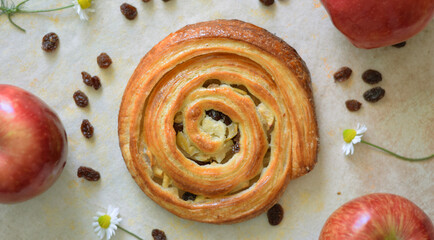 Freshly baked red apple and raisin roll for Sunday breakfast.