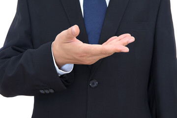 A man in a black suit makes an upward gesture with his hands