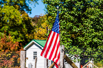 Bartow town in West Virginia countryside rural and American Flag closeup by house building in...