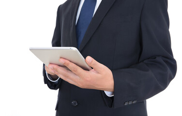Man in formal wear holding tablet in hand and standing in front of white background