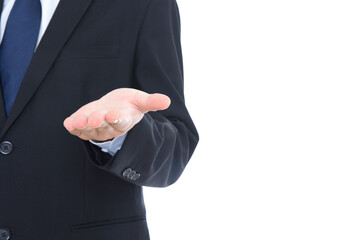 A man in a black suit stretches out his hand to make an upward gesture