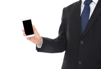 Male in formalwear standing in front of white background holding mobile phone in hand