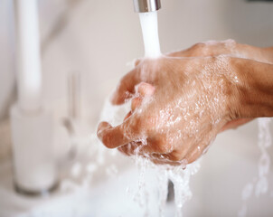 Washing hands under the water tap or faucet without soap. Hygiene concept detail. Beautiful hand...