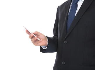 Male in formalwear standing in front of white background holding mobile phone in hand