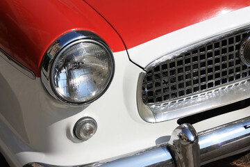 Right front grill of red and white car