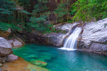 Naklejka premium The turquoise color water creek and waterfalls in Emerald Valley, in Anhui province, China.