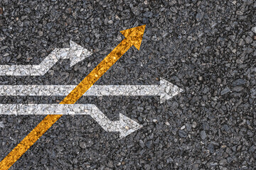 Different thinking and Business and technology disruption concept , Yellow arrow cross direction with white arrow on road asphalt. - obrazy, fototapety, plakaty