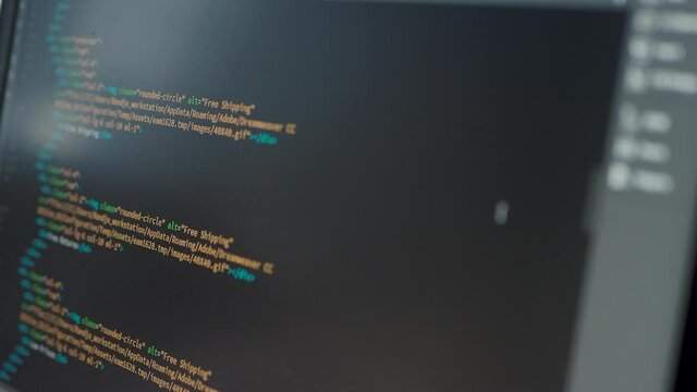 Developer is browsing html code on the computer screen. HTML Web Page Code Scrolling Programming code abstract technology background for software developer and Computer script concept.Scene A.