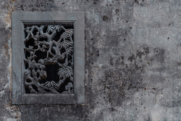 Vintage stone window sculptures in Xidi village, Anhui province, China.