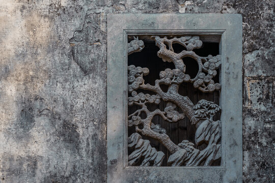 Vintage stone window sculptures in Xidi village, Anhui province, China.